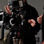 Film crew operates professional camera setup on set