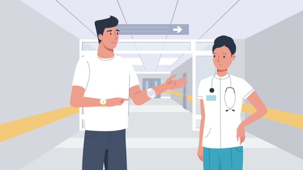 Doctor checks patient's blood pressure in hospital hallway